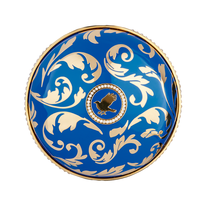 The bright blue cap is finished with precious metal enamel and adorned with dazzling Swarovski® crystals, each meticulously hand-placed by master jewelers. Its luxurious arabesque design