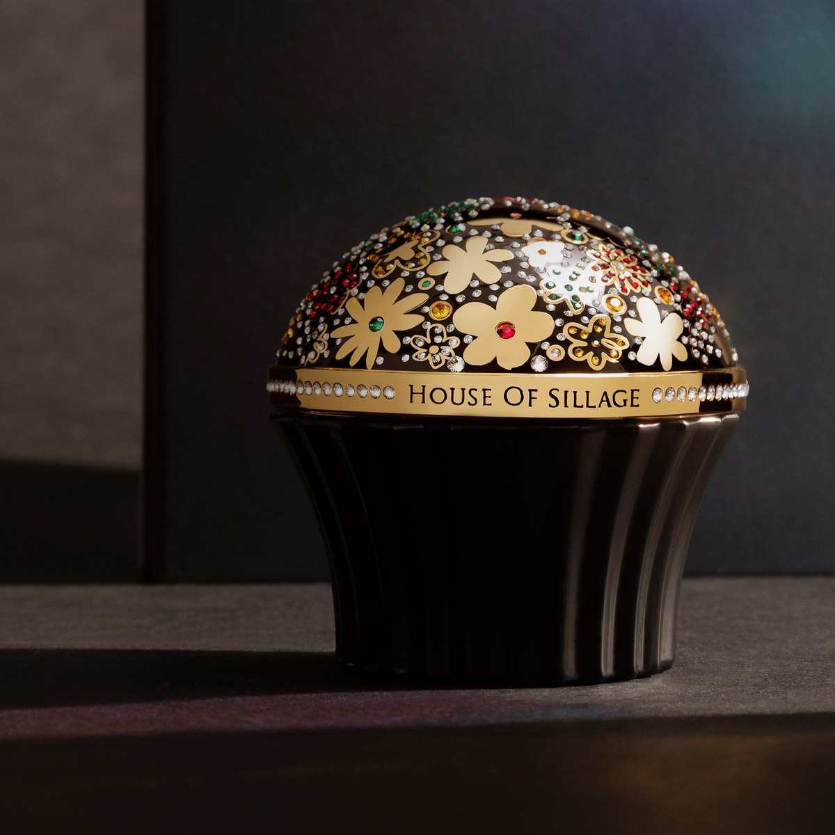Golden luxury cup with Swarovski crystal covers black fragrance bottle  bottle with perfume