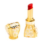 Luxurious red lipstick with gold casing featuring gemstones on a white background