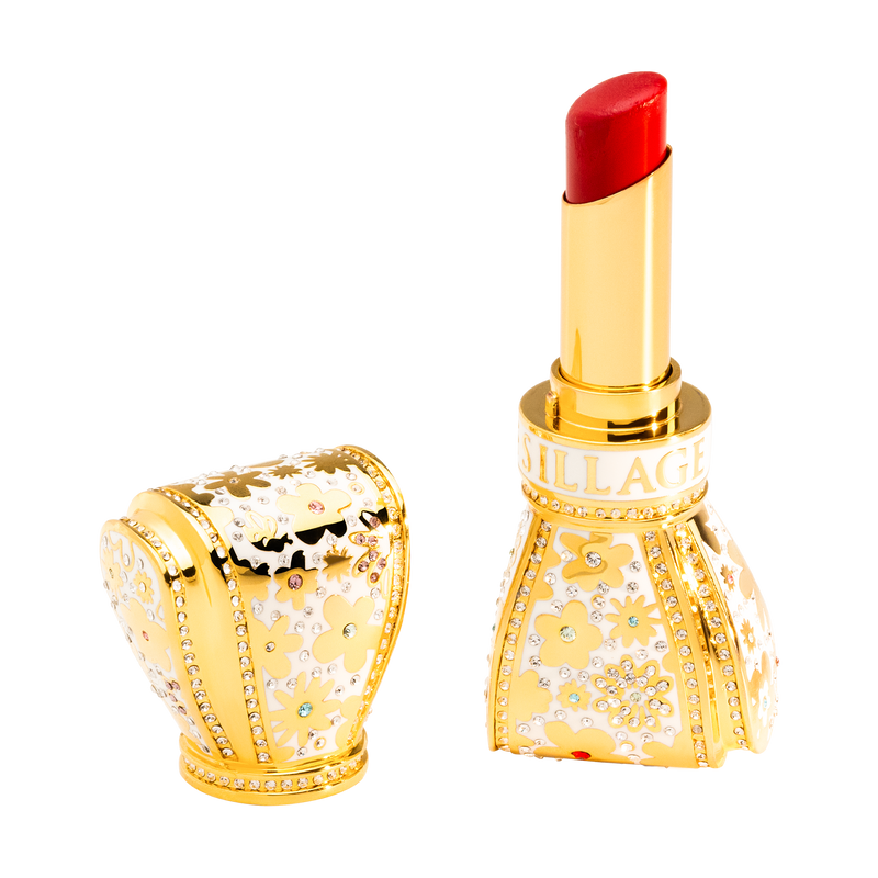 Luxurious red lipstick with gold casing featuring gemstones on a white background