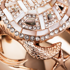 Close-up of a rose gold luxury niche fragrance cup  with intricate design and clear gemstones.