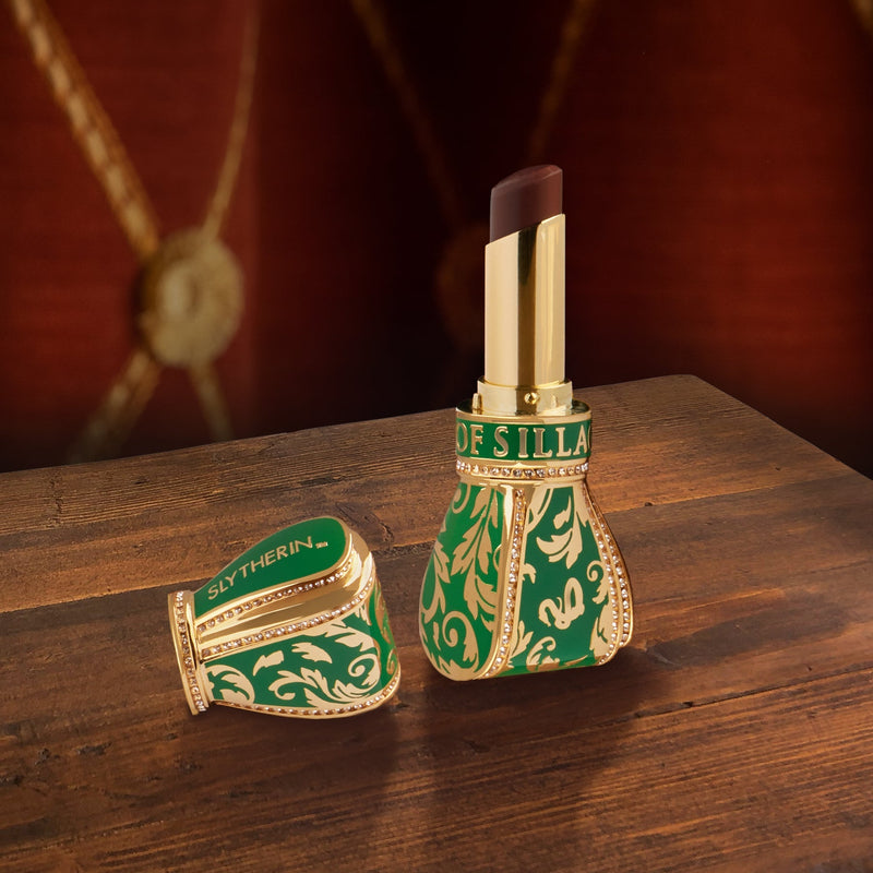 green lipstick case with Slytherin design