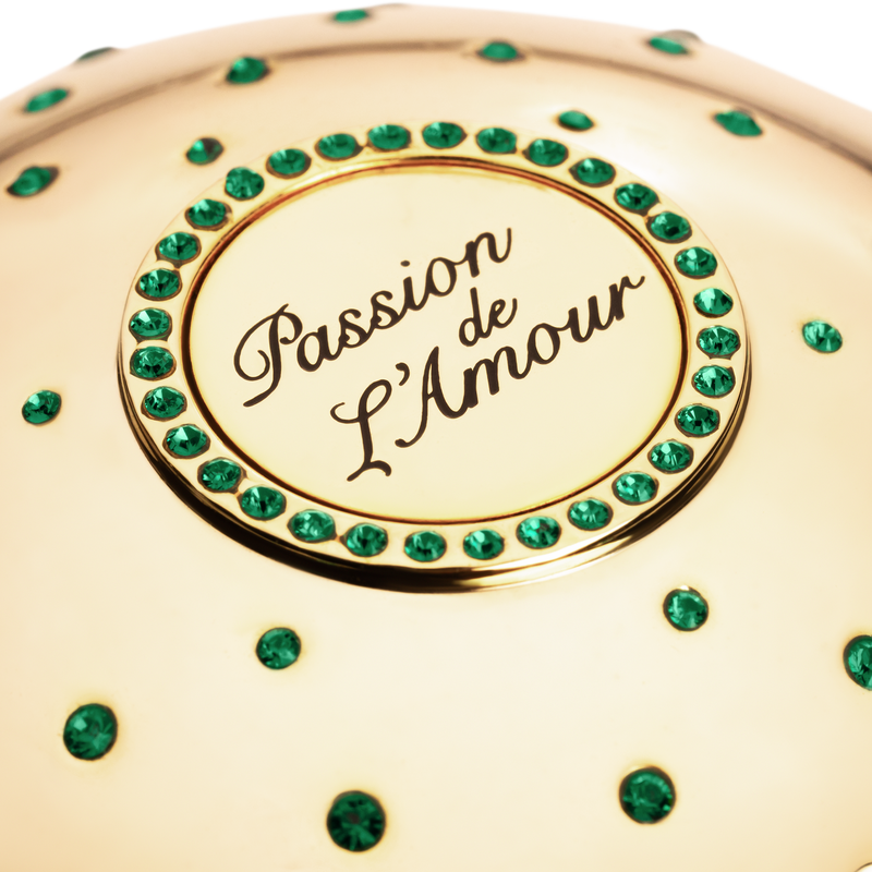 Gold niche fragrance cup  with 'Passion de L'Amour' text and green gemstones